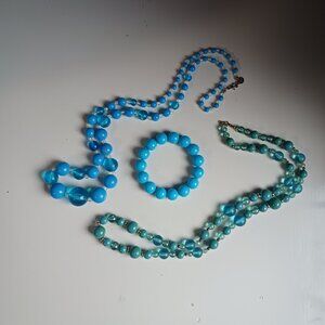 A pair of blue beaded necklaces and a bracelet